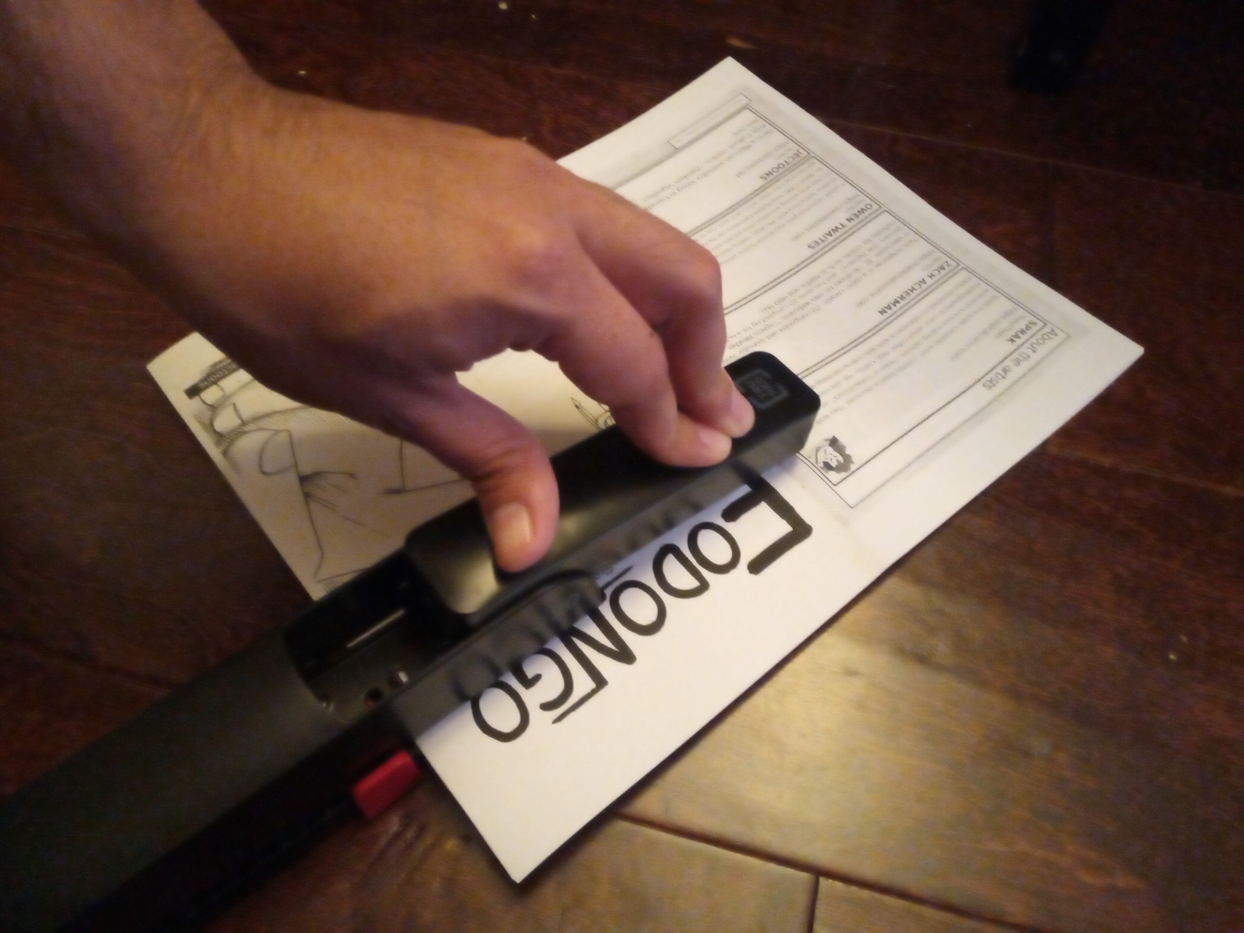 Wonky hand stapling Fodongo with long stapler.